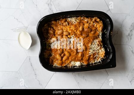 https://l450v.alamy.com/450v/2axjmb0/take-away-mexican-food-rice-with-kidney-bean-sour-cream-grated-mozzarella-cheese-and-salsa-sauce-pilaf-in-plastic-container-box-package-ready-2axjmb0.jpg