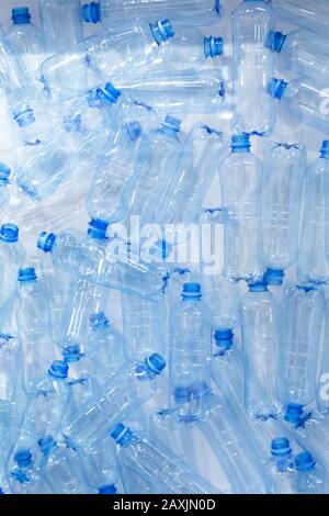 Pile of blue plastic bottles, concept of harm of plastic for ecology and planet, problems of ecology and pollution. Many empty plastic bottles for dri Stock Photo
