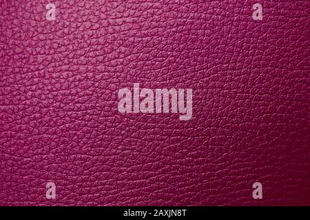 Texture of genuine leather raspberry burgundy maroon red magenta tone. Backdrop background textured effect for design. Artificial eco leather piece of Stock Photo