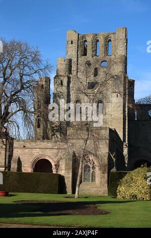 Remains of the cloisters at Keslo Abbey with the ruins of the West Tower of the Abbey in the background seen from the adjacent War Memorial garden. Stock Photo