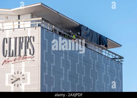 Southend on Sea, Essex, UK. 12th Feb, 2020. Local agencies are taking the chance as the wind drops to clear up after the destructive winds of storm Ciara. Roofing material which was blown off of the roof of the Cliffs Pavilion theatre has been cut away and allowed to drop to the ground Stock Photo