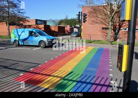 The rainbow painted LBGTQ supporting pedestrian crossing outside woodside high school haringey wood green london UK Stock Photo