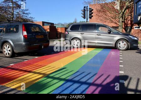 The rainbow painted LBGTQ supporting pedestrian crossing outside woodside high school haringey wood green london UK Stock Photo