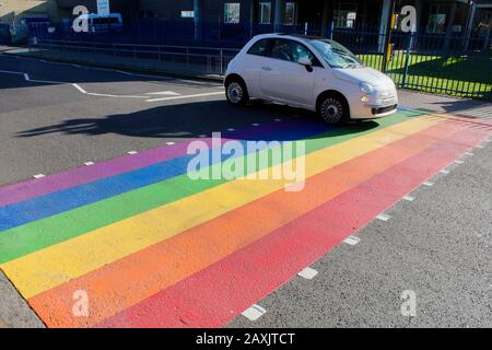 The rainbow painted LBGTQ supporting pedestrian crossing outside woodside high school haringey wood green london UK Stock Photo