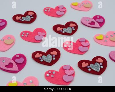 Red, pink and purple felt hearts with bling on a white background Stock Photo