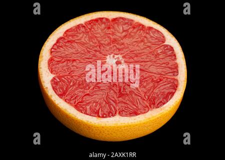 Citrus fruit red grapefruit closeup isolated on black background Stock Photo