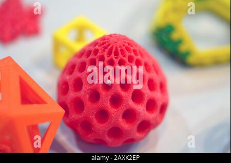 Objects printed by 3d printer. Bright colorful objects printed on a 3d printer on a table Stock Photo
