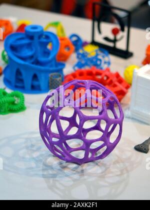 Objects printed by 3d printer. Bright colorful objects printed on a 3d printer on a table Stock Photo