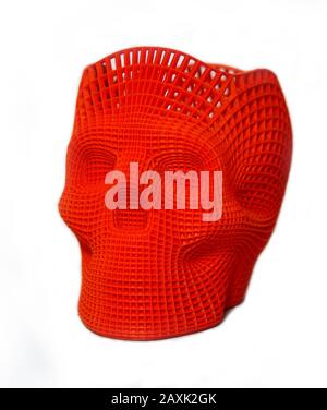 Skull printed with plastic of red color on a 3d printer Isolated on white background. Stock Photo
