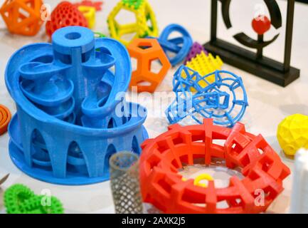 Objects printed by 3d printer. Bright colorful objects printed on a 3d printer on a table Stock Photo
