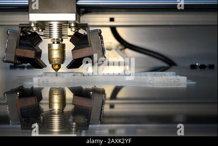 3D printer print isolated objects on mirror reflective surface close-up. Modern 3D printing technology Stock Photo