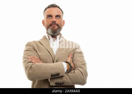 Low angle of man wearing smart casual clothes with arms crossed isolated on white background with copy space advertising area Stock Photo