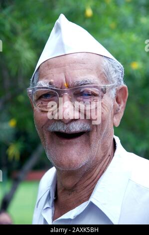 Mumbai, Maharashtra, India- Sep. 08, 2011 - Soft focus Portrait of Indian wrinkled face Old Man wearing India's iconic Gandhi topi or Gandhi cap Stock Photo