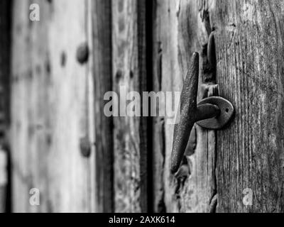 Detail of the doorknob or handle of an old vintage door - Black and White revealed. Talavera de la Reina Stock Photo