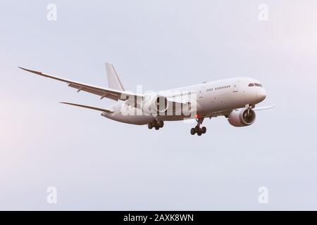 Large white passenger airplane landing approach airport Stock Photo