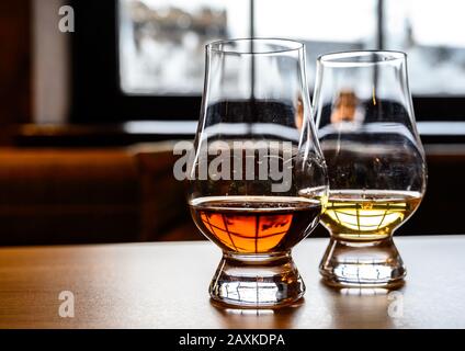 Flight of Scottish whisky, tasting glasses with variety of single malts or blended whiskey spirits on distillery tour in Scotland, UK