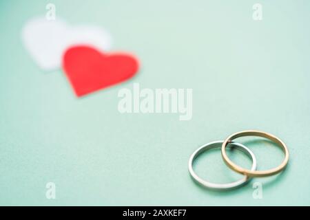 Romantic wedding rings with hearts still life wallpaper with copy space. Concept for valentine's day, engagement, couple love, anniversary, card, cove Stock Photo