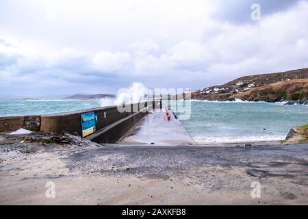 PORTNOO, COUNTY DONEGAL / IRELAND - FEBRUARY 10 2020 : Waves crashing into the harbour during storm Ciara. Stock Photo