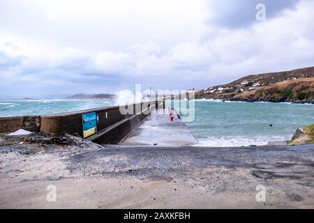 PORTNOO, COUNTY DONEGAL / IRELAND - FEBRUARY 10 2020 : Waves crashing into the harbour during storm Ciara. Stock Photo