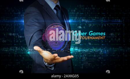 A businessman in a suit touch screen with esport cyber games symbol hologram. Man using hand on virtual display interface. Video gaming tournament and Stock Photo