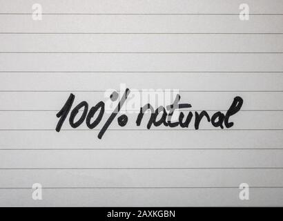 Writing 100% natural on white label on white background. Stock Photo