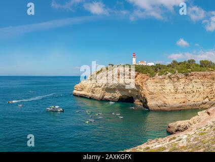 Lighthouse Farol de Alfanzina on top of the sea cave Gruta do Paraíso, Cavoeiro,   Portugal, Stock Photo