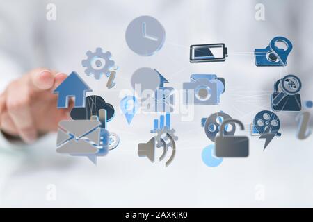 Businessman pressing a virtual projection of different icons connected with cloud Stock Photo