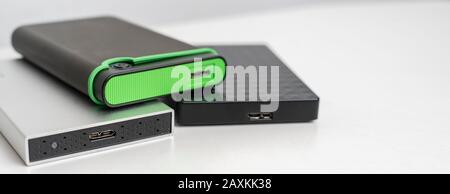 the three external hdd drives one the shelf, data backup storage Stock Photo