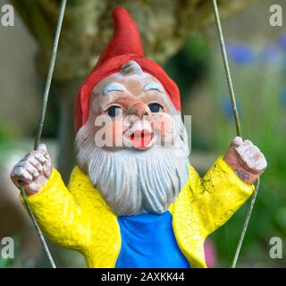 garden dwarf in home garden, gnome decoration Stock Photo