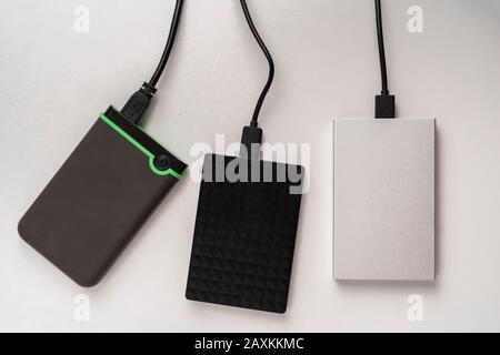 the three external hdd drives one the shelf, data backup storage Stock Photo