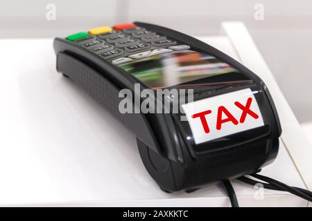 paying tax. close up view of pos terminal with word tax on it Stock Photo