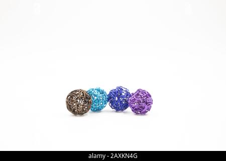 Photo of colorful metal wire balls against a white background Stock Photo
