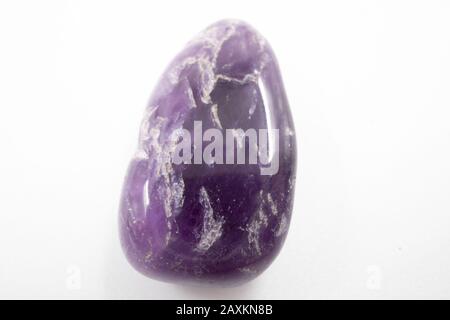 Pink natural mineral stone against a white background Stock Photo
