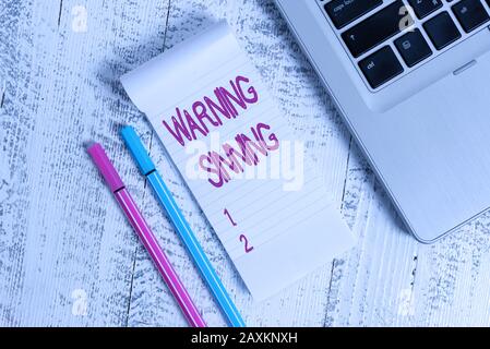 Text sign showing Warning Sinning. Business photo text stop the action which is believed to break the laws Trendy laptop blank ruled notepad pens lyin Stock Photo