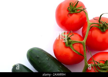 Tomatoes and cucumbers on a completely white background Stock Photo