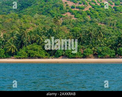 Landscape of Indian Ocean from Tarkarli Beach with blue water and green trees Stock Photo