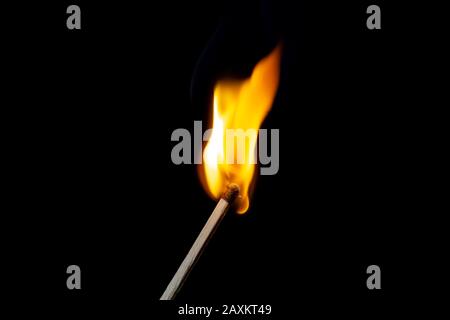Flame on the matchstick over black background with place for text Stock Photo