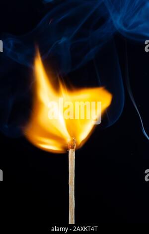 Flame and smoke on the matchsticks over dark background Stock Photo