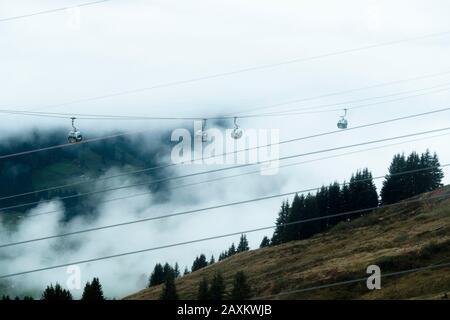 Cable car travelling from Grindelwald up to First in the autumnal mist, Bernese Oberland, Canton of Bern, Switzerland Stock Photo