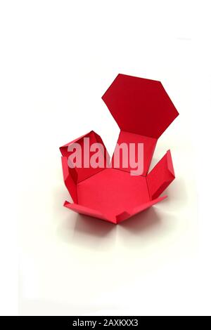 Geometric shape cut out of paper and photographed on grey background.Geometry net of Hexagonal prism. 2-dimensional shape that can be folded to form a Stock Photo