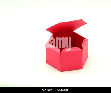 Geometric shape cut out of paper and photographed on grey background.Geometry net of Hexagonal prism. 2-dimensional shape that can be folded to form a Stock Photo
