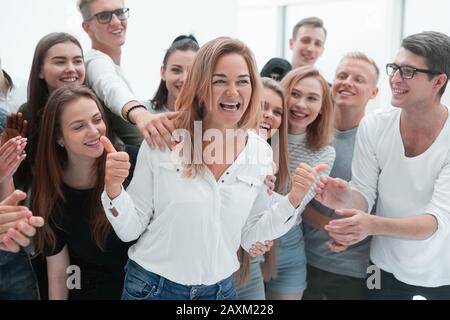 group of young people supporting their happy leader Stock Photo