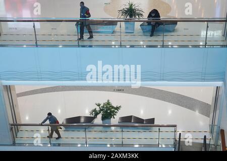 Beijing, China. 12th Feb, 2020. Workers disinfect the handrails inside the 'Joy City' shopping mall in Chaoyang District in Beijing, capital of China, on Feb. 12, 2020. Work and production has resumed gradually in enterprises, communities and malls, etc. in Beijing since Feb. 10 with comprehensive measures taken to prevent and control the epidemic caused by the novel coronavirus. Credit: Ju Huanzong/Xinhua/Alamy Live News Stock Photo