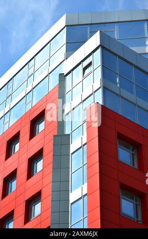 red-blue facade of urban buildings. On a bright sunny day with blue sky Stock Photo