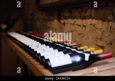 France Burgundy 2019-06-19 Shelf on wooden rack in wine store. Wooden rack with red wine. Concept wine production, cellar, vault, grand cru, premier c Stock Photo