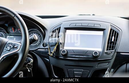 Car navigation system. GPS device in car help driver to find the way. Blank screen with place for text. The concept of artificial intelligence. Stock Photo