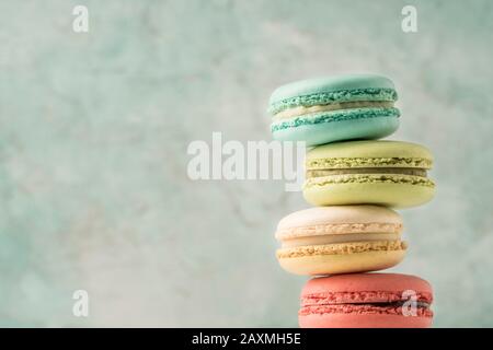 closeup pile of colorful french macaroons over green with copy space Stock Photo