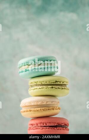 closeup pile of colorful french macaroons over green with copy space Stock Photo