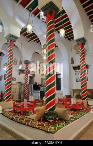 TUNIS, TUNISIA - JANUARY 01, 2020: The colorful interior of El Mrabet Cafe, located inside the medina, with twisted columns and a high vaulted ceiling Stock Photo