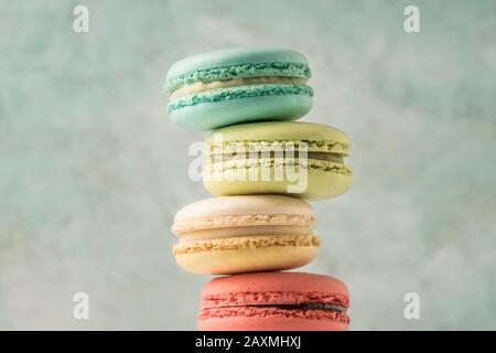 closeup pile of colorful french macaroons over green with copy space Stock Photo